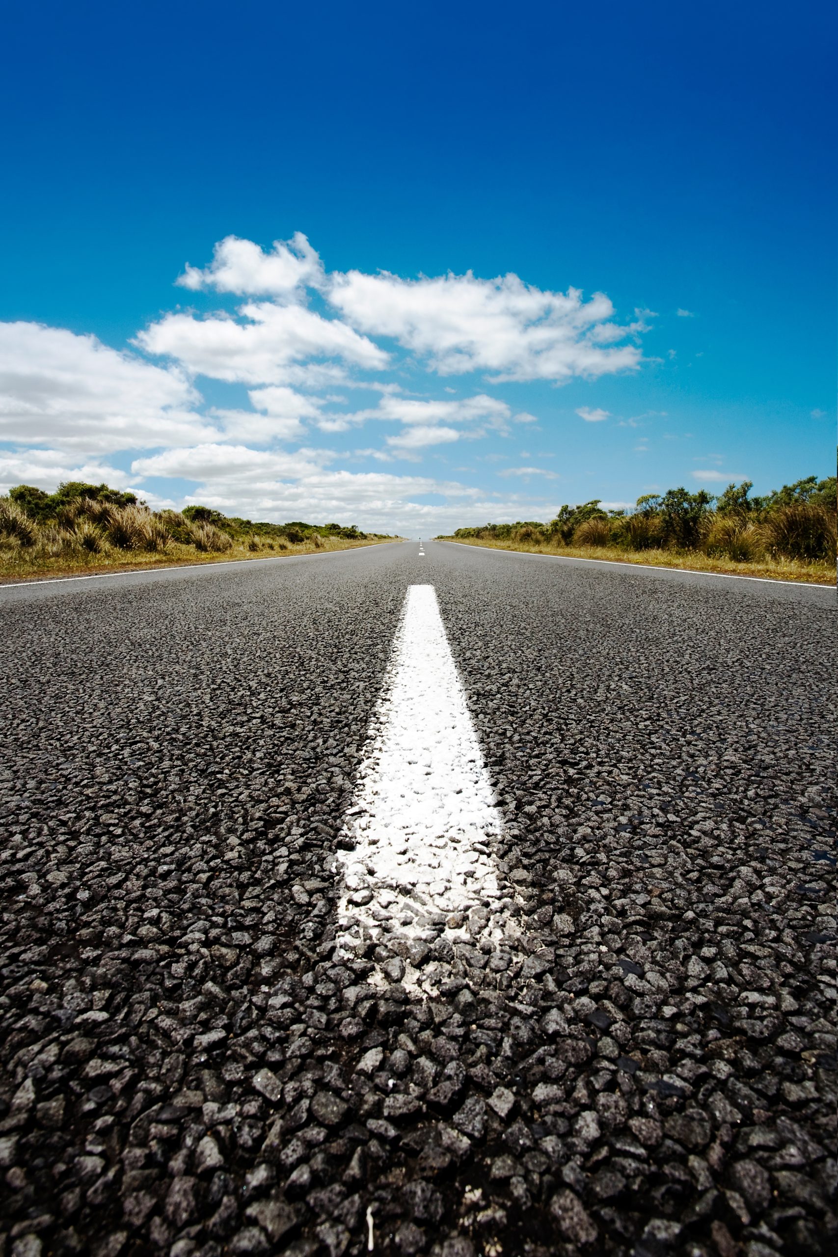 vertical shot asphalt road blue sky scaled