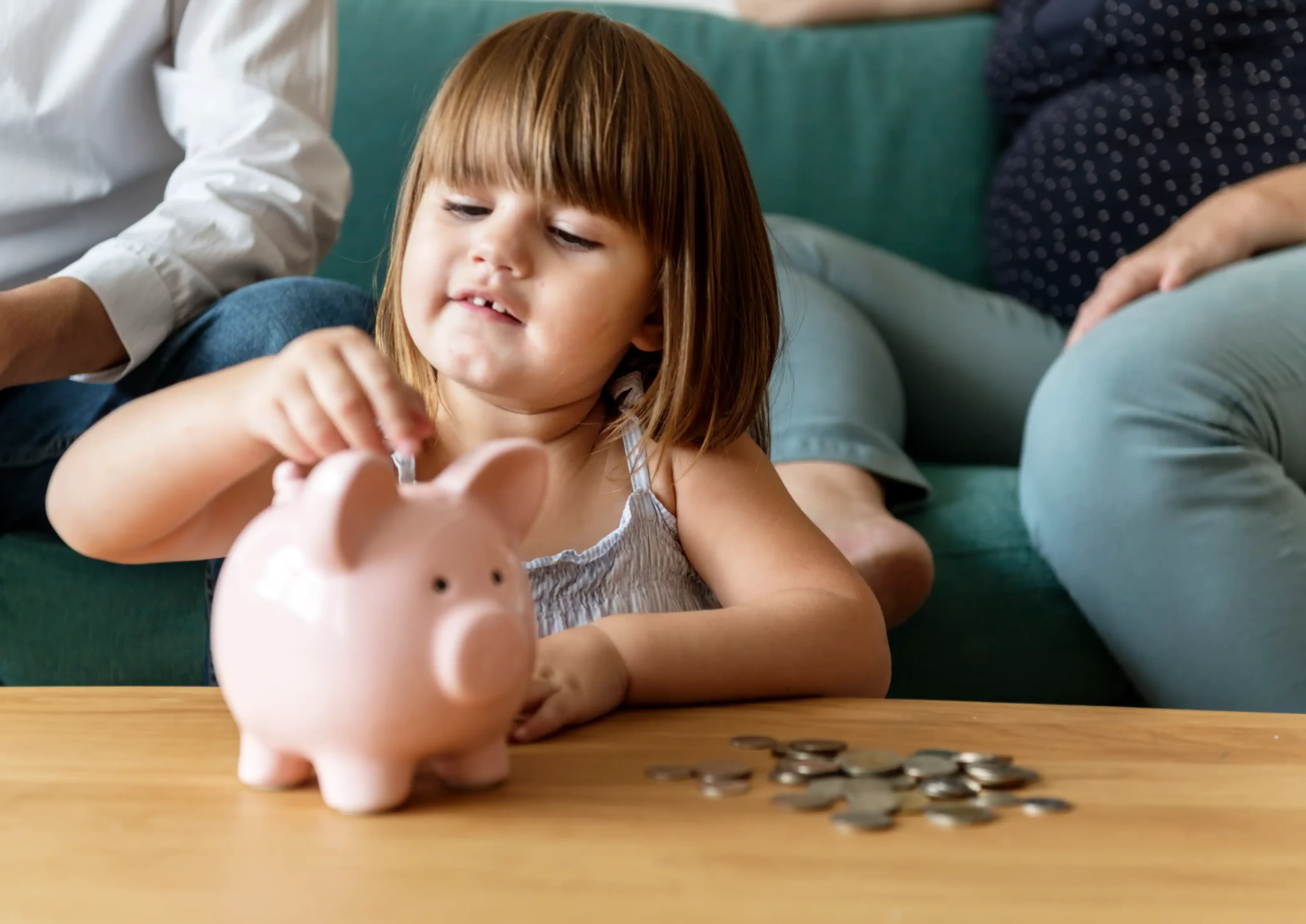 family saving money piggy bank scaled