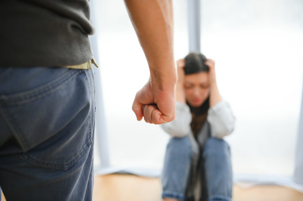quarrel violence husband beats wife home angry man raises his fist frightened woman
